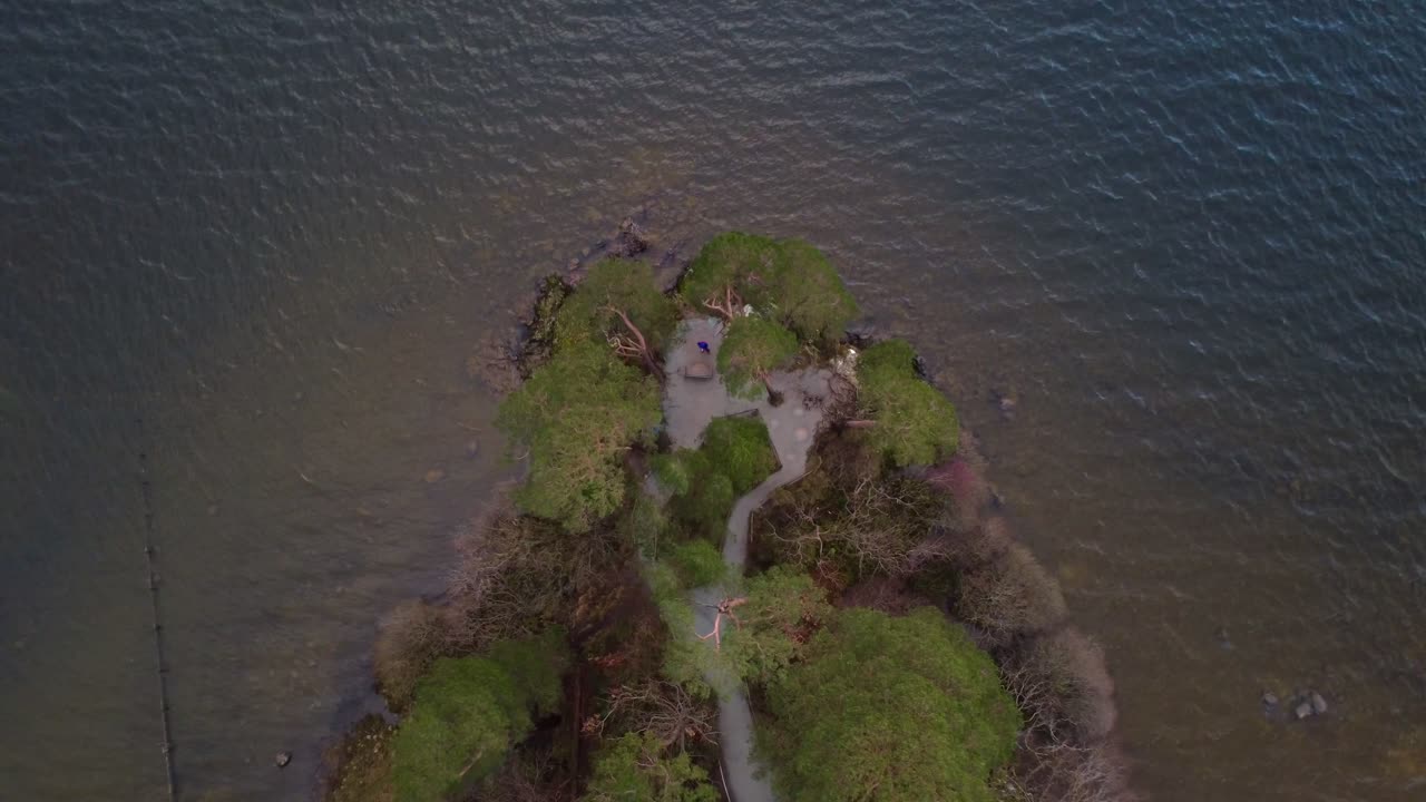 Aerial view of drone looking down on peninsula with small ripples in the lake - Friar's Crag, Keswick, Lake District