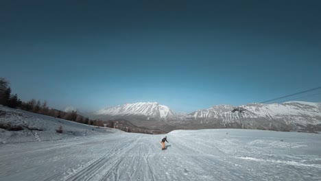 FPV-tracking-shot-of-a-snowboarder-traveling-down