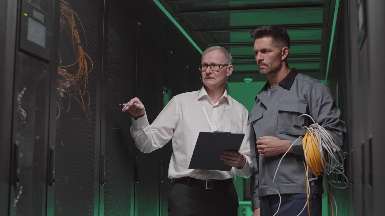 Technicians inspecting servers in data center