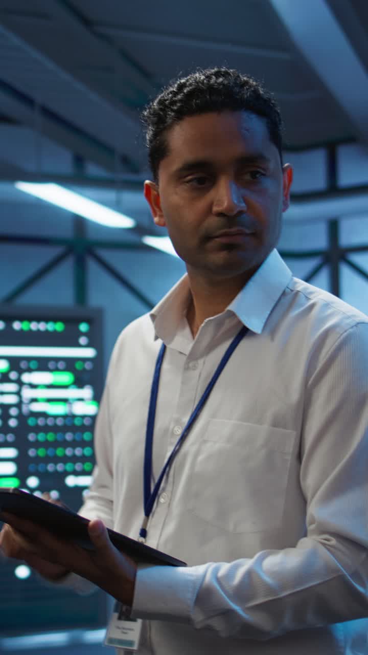 IT Professional Working on Tablet in Server Room