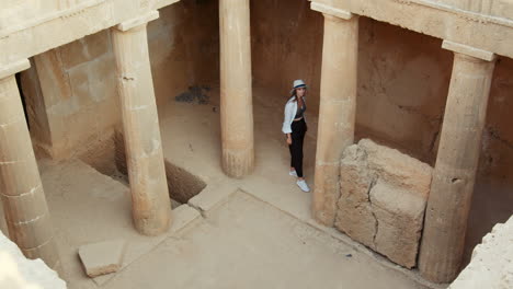 woman exploring an ancient tomb in cyprus