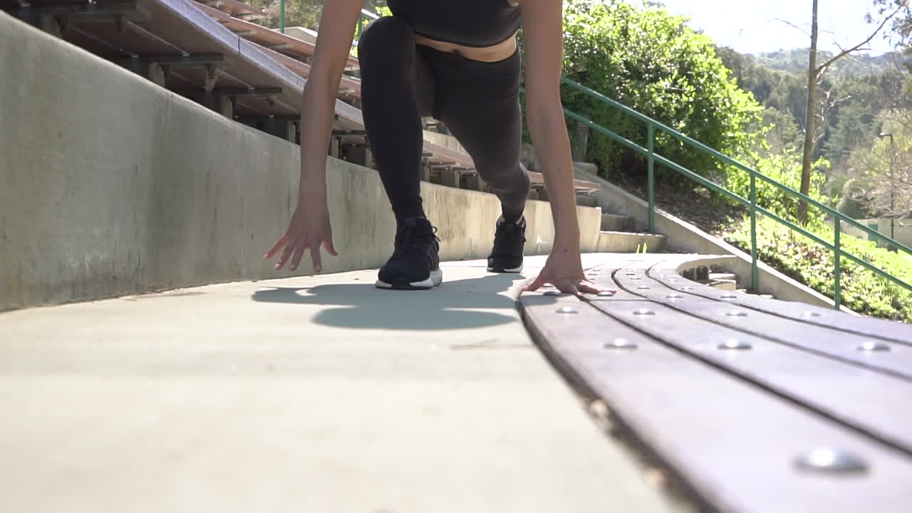 Female stretching in park.