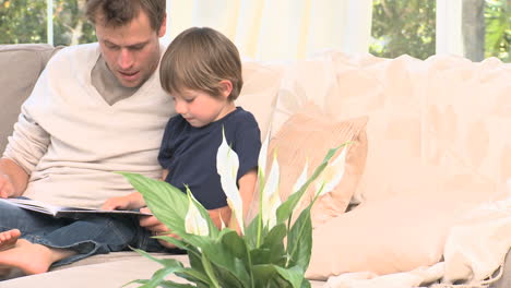 adorable boy on a sofa with his father