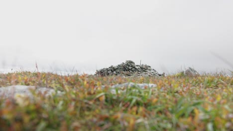 stone cairn in a misty mountain landscape