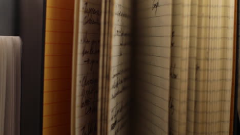 handheld shot moves away from upright old notebooks