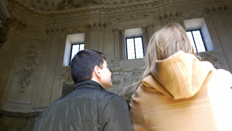 two people making photos with pad inside ancient building