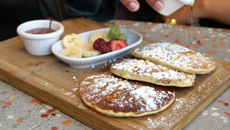 delicious pancakes with honey and fruit