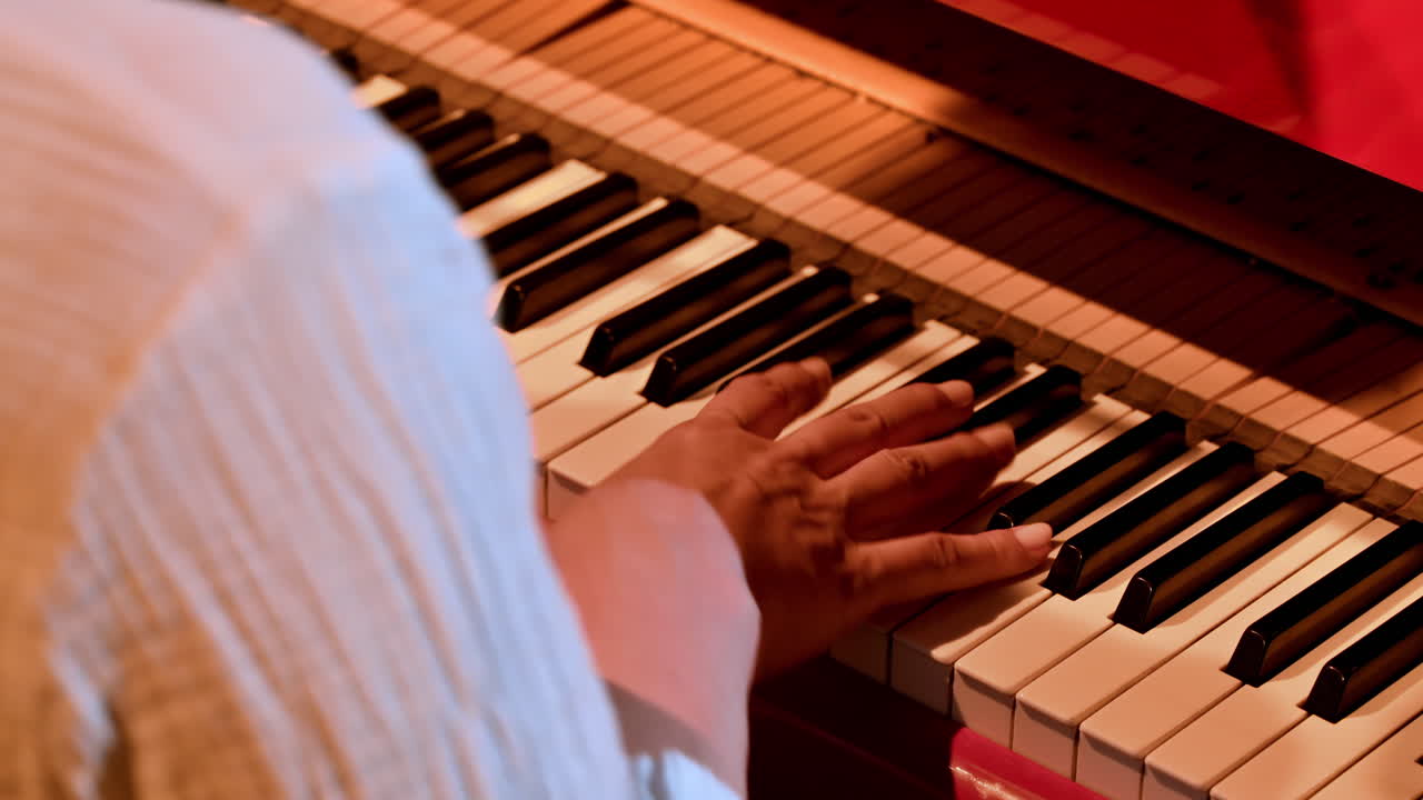 Elderly woman playing a red piano