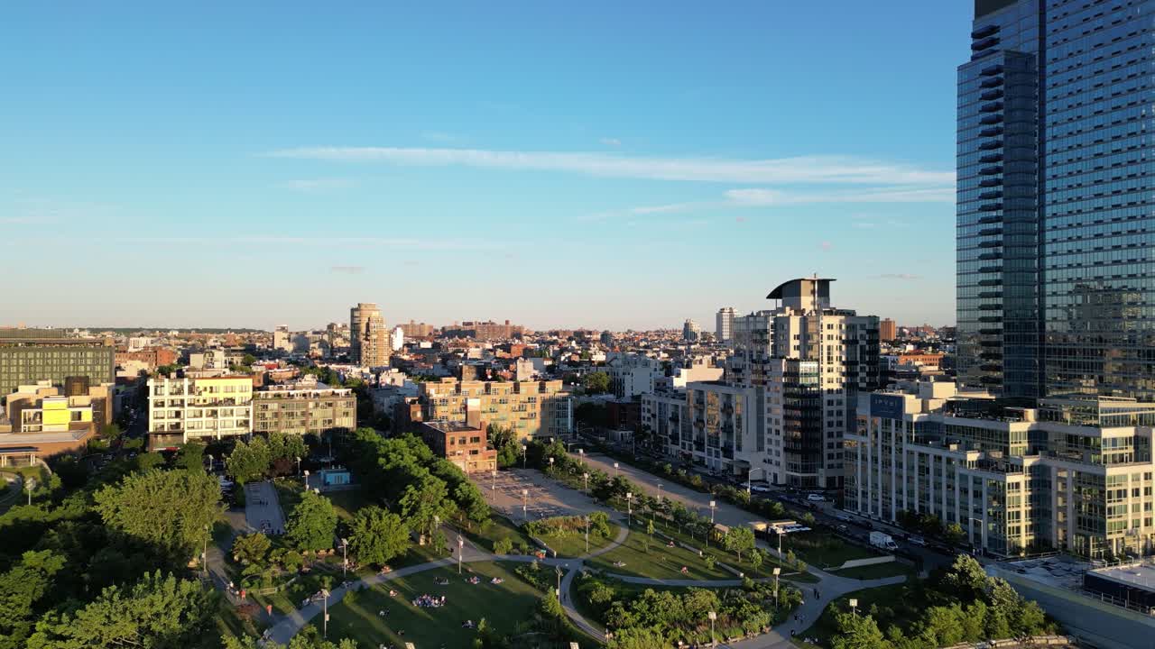 A cinematic horizontal drone push-in shot over Williamsburg, Brooklyn, gradually revealing the vibrant urban landscape and the iconic skyline in stunning detail.