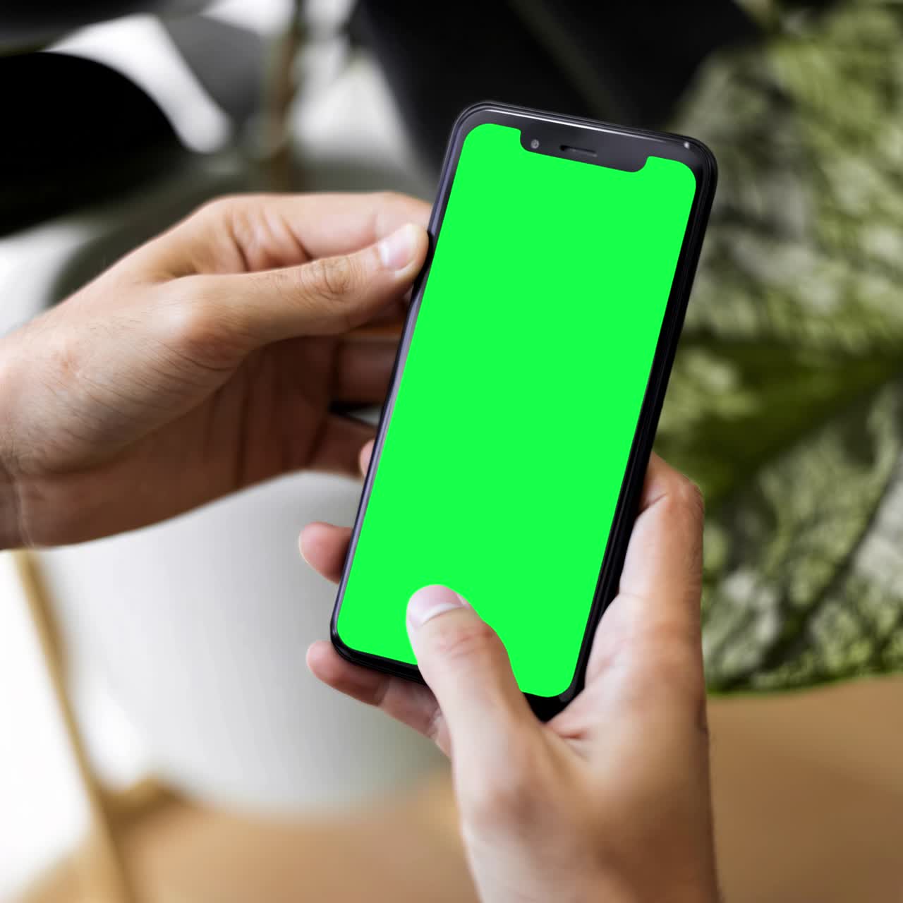 Mobile phone screen in hands of a woman live mockup animation, transparent 4K video, green screen