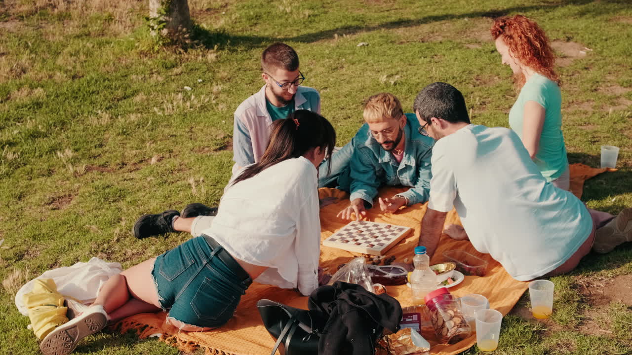 Friends Playing Checkers at a Picnic