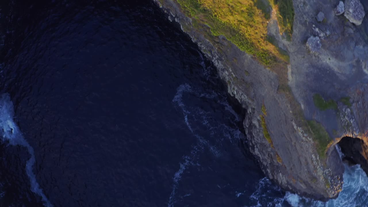 Bird's-eye view circles around the Bridges of Ross, revealing the intricate top edges of the natural rock formation