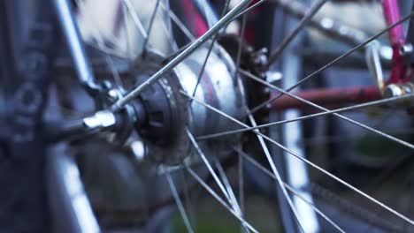 slow motion camera pan over a wet oldschool locked bicycle