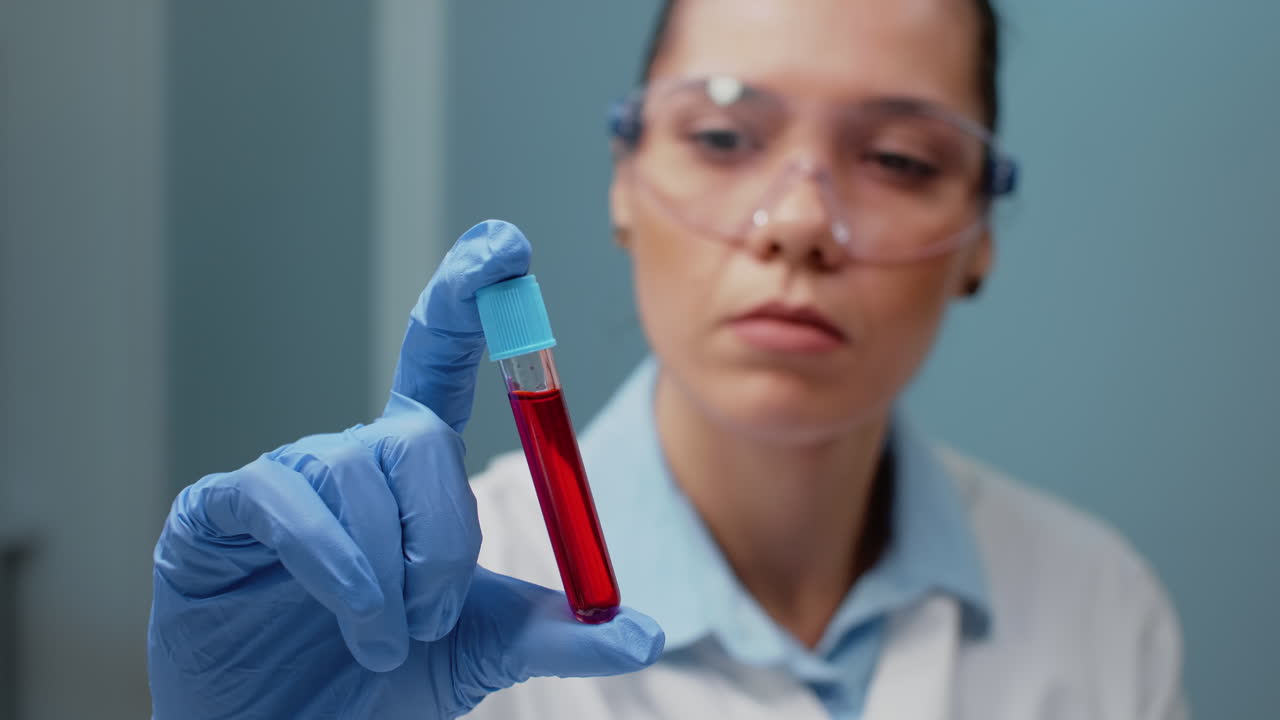 Scientist Examining Blood Sample in Test Tube