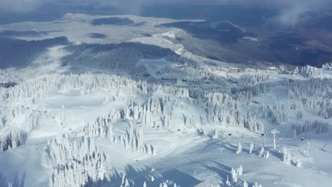 snowscape mountains with cable cars and skiing people at jahorina in bosnia and herzegovina