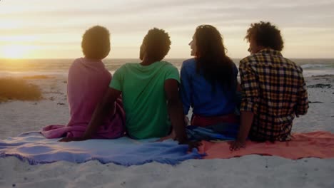 Animation-of-red-shapes-over-diverse-group-of-friends-at-beach