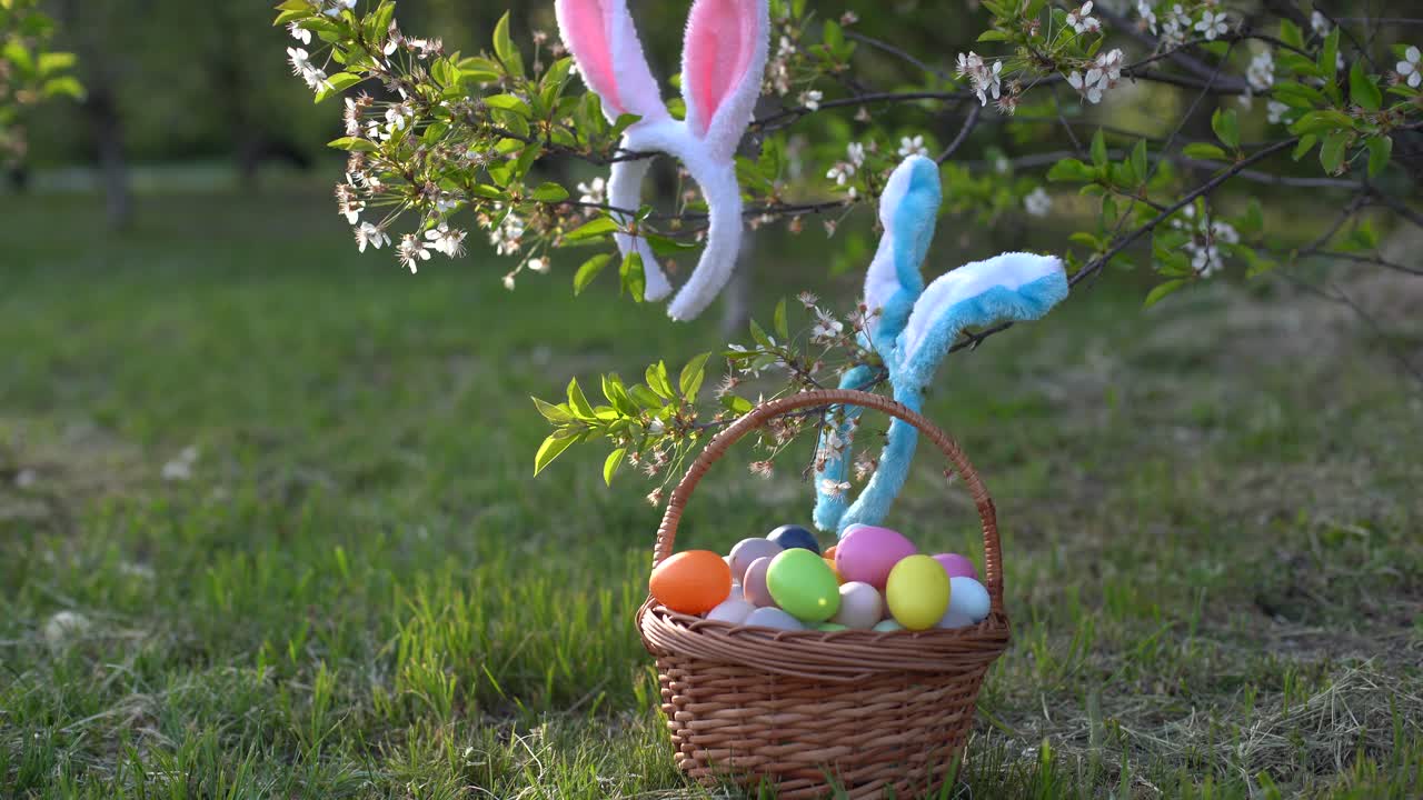 painted Easter eggs in basket on grass. Traditional decoration in sun light