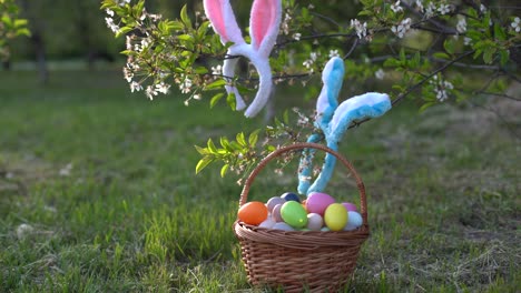 painted-Easter-eggs-in-basket-on-grass.-Traditional-decoration-in-sun-light