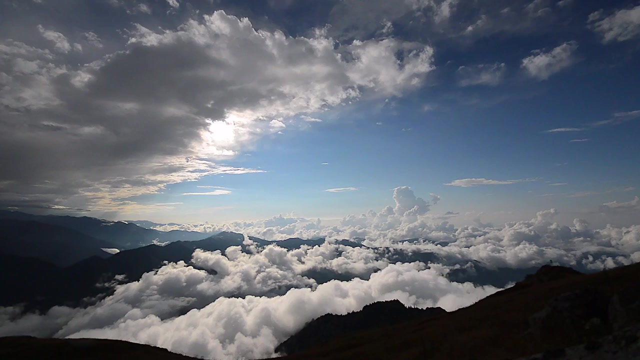Breathtaking View of Mountain Peaks Above the Clouds