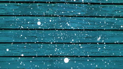 animación de la nieve cayendo sobre la superficie de madera azul