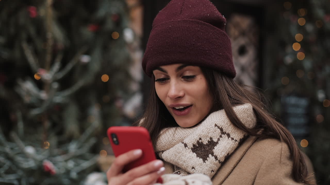 Woman using smartphone outdoors during winter