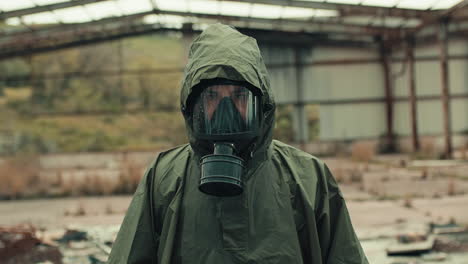 man salutes with a gas mask on