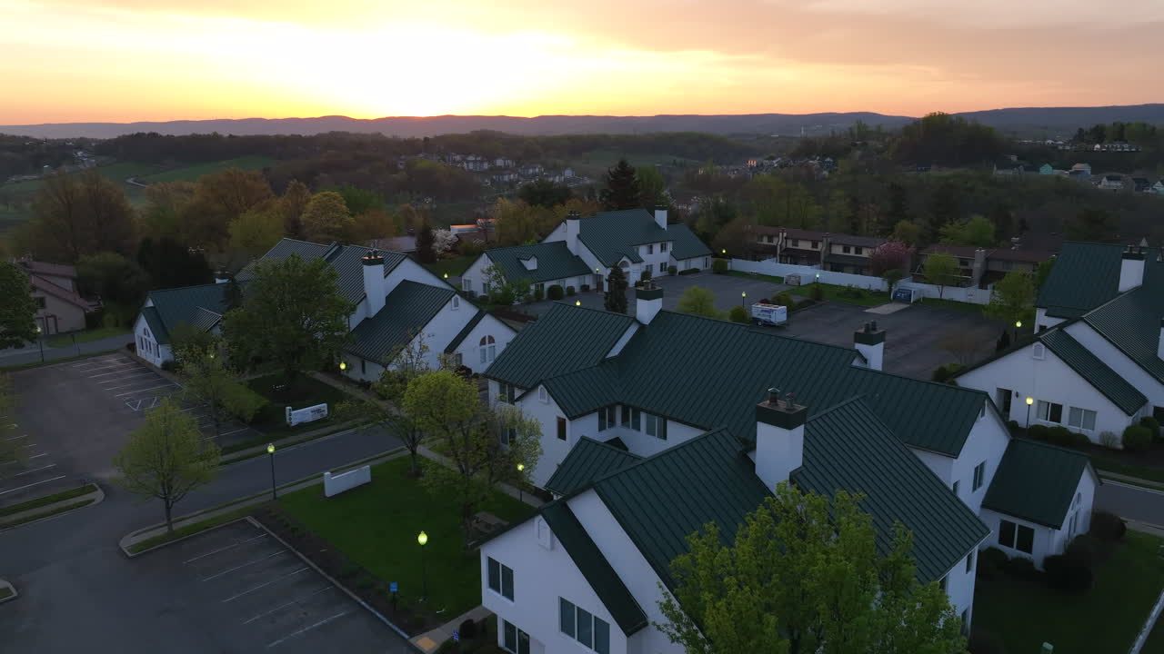 White and green buildings at night. Sunset over mountain in vacant business park, doctor offices in USA.