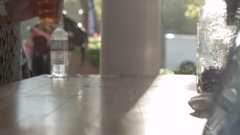 man drinking beer at outdoor bar