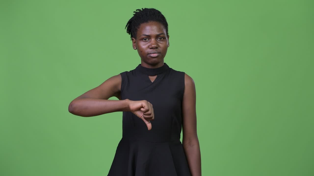 Young upset African businesswoman giving thumbs down