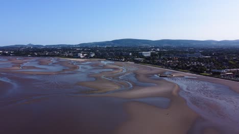 Orbiting-Shot-of-Sandymount-Beach,-Dublin,-Ireland-during-a-Low-Tide