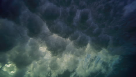 Underwater-view-of-frothy-wisps-of-air-bubbles-from-breaking-wave