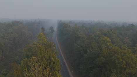 drone shot of nepal highway inside the wild forest covered with fog and smoke