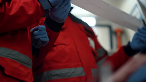 Closeup-doctors-checking-patient-electrocardiogram-in-emergency-car