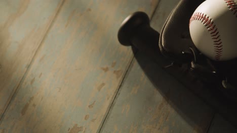 Close-Up-Studio-Baseball-Still-Life-With-Bat-Ball-And-Catchers-Mitt-On-Aged-Wooden-Floor-2