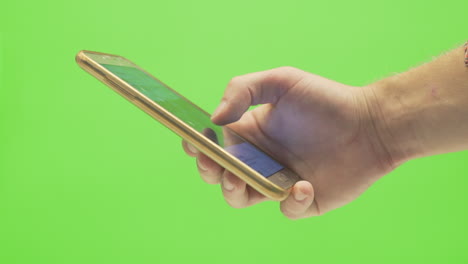 a single hand scrolling through a social media platform with a smartphone on a green screen background