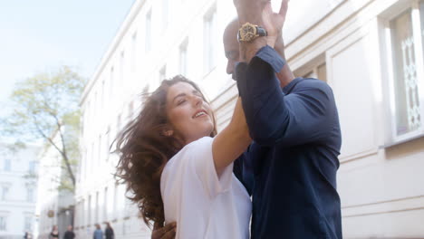 happy interracial couple dancing bachata in the old town street 1