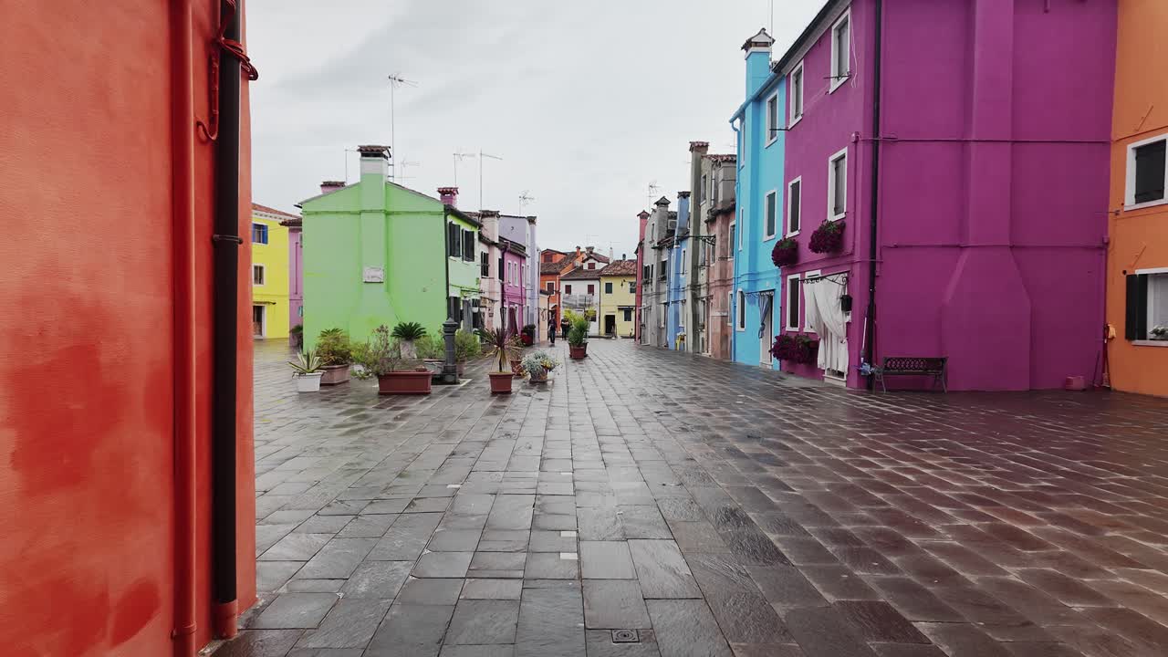 Burano Paved street with Colourful painted houses on wet day, Slow POV