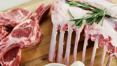 beef rib chops and ingredients on wooden floor