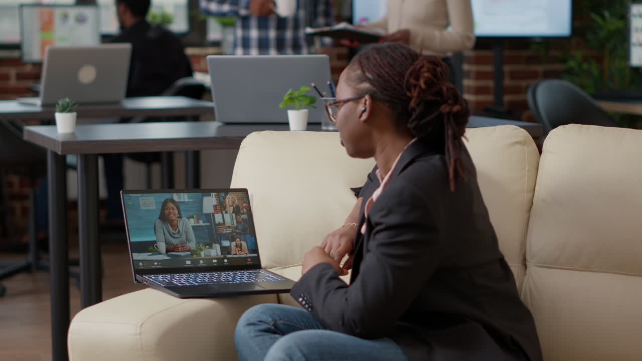 Business woman talking to colleagues on online web conference