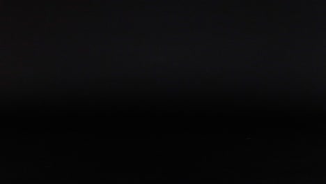 two toy cars moving across a dark background