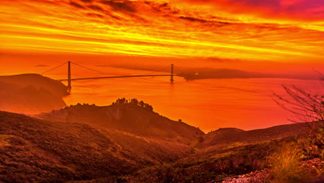 dramatic burning colored sky over golden gate bridge in san francisco bay, california