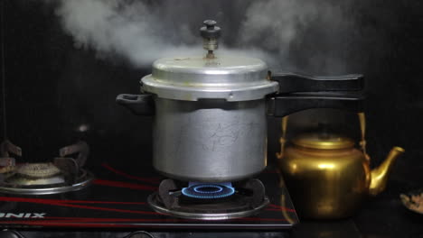 A-cooker-is-whistling-with-smoke-in-an-indian-kitchen