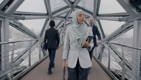 business professionals walking on a modern city bridge