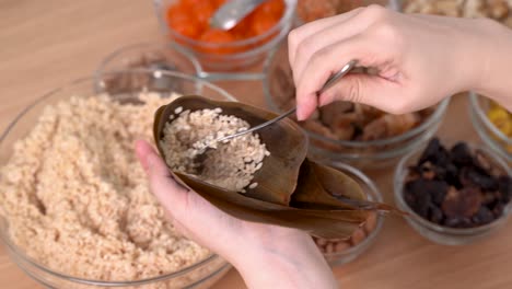 making zongzi food - preparing and wrapping chinese rice dumpling.