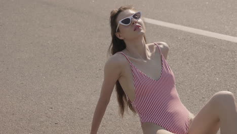 woman in striped swimsuit on the street