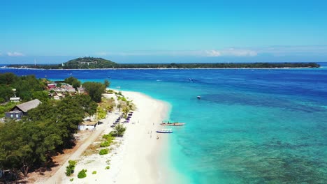Idyllic-vacation-destination-with-hotels-and-villas-near-exotic-beach-washed-by-calm-clear-water-of-turquoise-lagoon-in-Indonesia