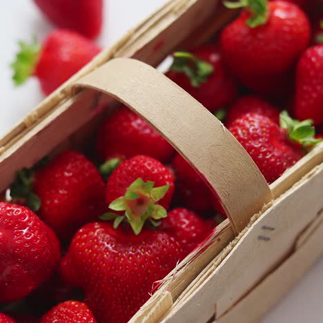 fresh healthy strawberries in a wooden box on white background