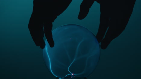 hands holding a plasma ball