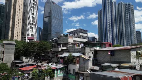 contrast in living conditions, manila city poor slums and neighborhood in front of central business district modern luxury apartments and buildings