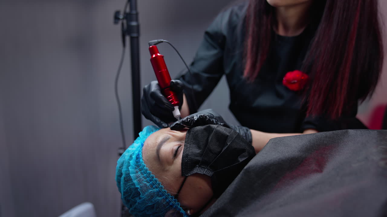 Close up view of cosmetology permanent technologies. Pretty woman cosmetologist working with permanent make up.